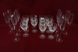 Set of twelve Stuart crystal wine glasses and twelve champagne flutes. Max. H27.