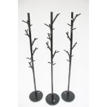 Three contemporary coat stands.