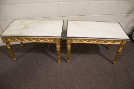 A pair of contemporary marble top coffee tables.