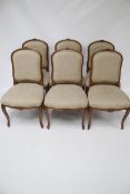 A set of six contemporary wood frame dining chairs.
