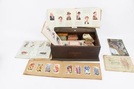A quantity of vintage cigarette cards in packets and albums,