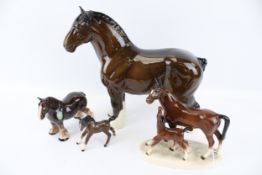 A collection of four assorted ceramic horse figurines. Including Beswick Shirehorse, etc. Max.