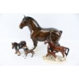 A collection of four assorted ceramic horse figurines. Including Beswick Shirehorse, etc. Max.