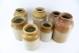 A collection of seven assorted vintage stoneware storage jars. Max.