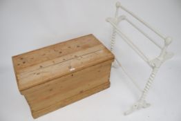 A vintage pine blanket box and a painted towel rail.