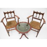 A pair of early Ercol open armchairs.
