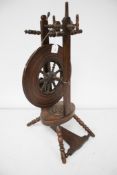 A vintage oak spinning wheel.