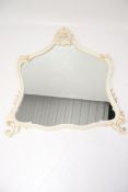 A contemporary wall overmantel mirror in a cream and gilt frame.