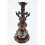 An early 20th century Japanese bronze candlestick with champleve enamel lotus decoration.