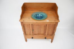 A Victorian pine wash stand with inset glass bowl.