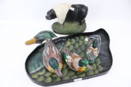 A hand painted papier mache mallard duck tray with three ducks and cast a metal pig door stop