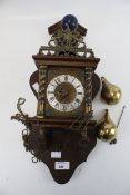 A Dutch style wall clock with pendulum and brass weights,