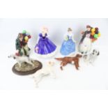 A collection of eight assorted ornamental figurines.