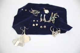 Twelve pairs of silver earrings of various designs