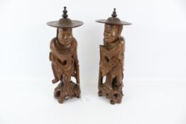A pair of 20th century Chinese wood carved figures.