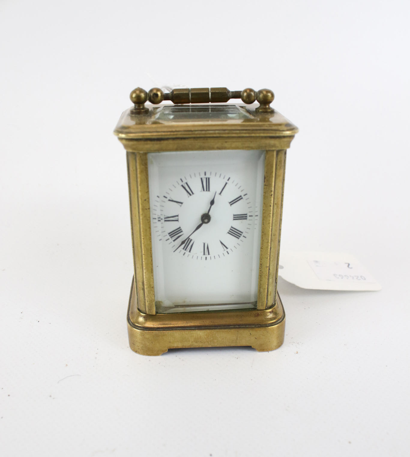 A miniature brass carriage clock.