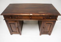 A contemporary hardwood twin pedestal desk. With three drawers over two cupboards.