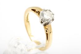 A diamond solitaire ring. The round bril