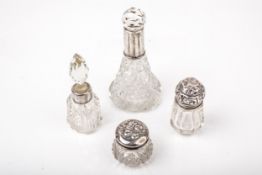 Two silver mounted clear cut glass scent bottles and two similar small dressing table bottles.
