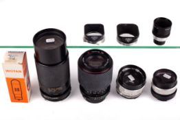 An assortment of camera lenses and accessories. To include Rollei lens hoods.