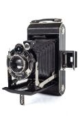 A Kodak 620 Art Deco folding bellows camera. With a 10.5cm f6.3 Anastigmat lens, and leather case.