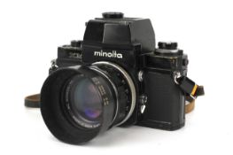 A Minolta XM 35mm SLR camera. Black, serial number 2116595. With a Minolta 58mm f1.