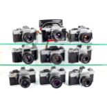 Nine assorted Praktica 35mm SLR cameras.
