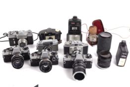 An assortment of cameras to include three Olympus OM10 cameras, Zenit -B,