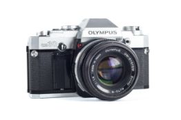 An Olympus OM30 35mm SLR camera. With a 50mm f1.8 Zuiko Auto-S lens.