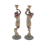 A pair of circa 1900 polychrome spelter candlesticks.