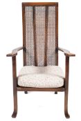 An unusual early 20th century high back colonial bergere caned open armchair.