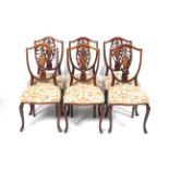 A set of six Edwardian mahogany inlaid shield back chairs.