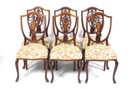 A set of six Edwardian mahogany inlaid shield back chairs.