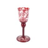 An early 19th century Bohemian ruby cased engraved glass goblet. Decorated with hunting scenes, 22.