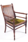 A James Shoolbred & Co, Arts and Crafts walnut open armchair.