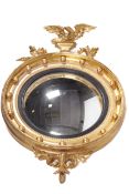 A 20th century George III style gilt gunshot convex mirror.