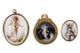 A 19th century 'Grand Tour' miniature of Cupid on a black ground and two oval porcelain panels.