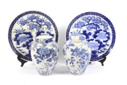 A pair of late 19th century Japanese porcelain blue and white porcelain ginger jars and covers and