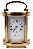 Wynne & Co, Gloucester Road, an oval brass cased carriage clock, in a leather case.