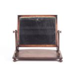 A Regency mahogany dressing table mirror with beaded bow front base.