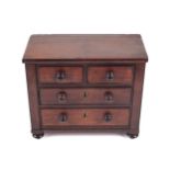 A 19th century apprentice piece in form of a mahogany chest of drawers.