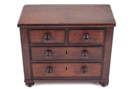 A 19th century apprentice piece in form of a mahogany chest of drawers.