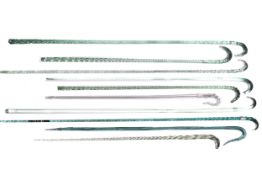 Ten Victorian clear and lightly coloured glass twist canes with crook handles.