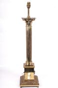 A large brass electric Corinthian Column lamp on a square stepped base and socle.