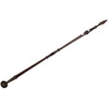 An old hardwood and cast iron pole spear with short spear head and spherical end.