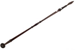 An old hardwood and cast iron pole spear with short spear head and spherical end.