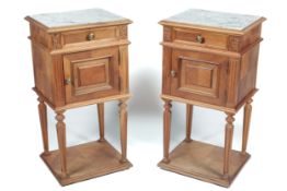 A pair of Louis XVI style French bedside cabinets.