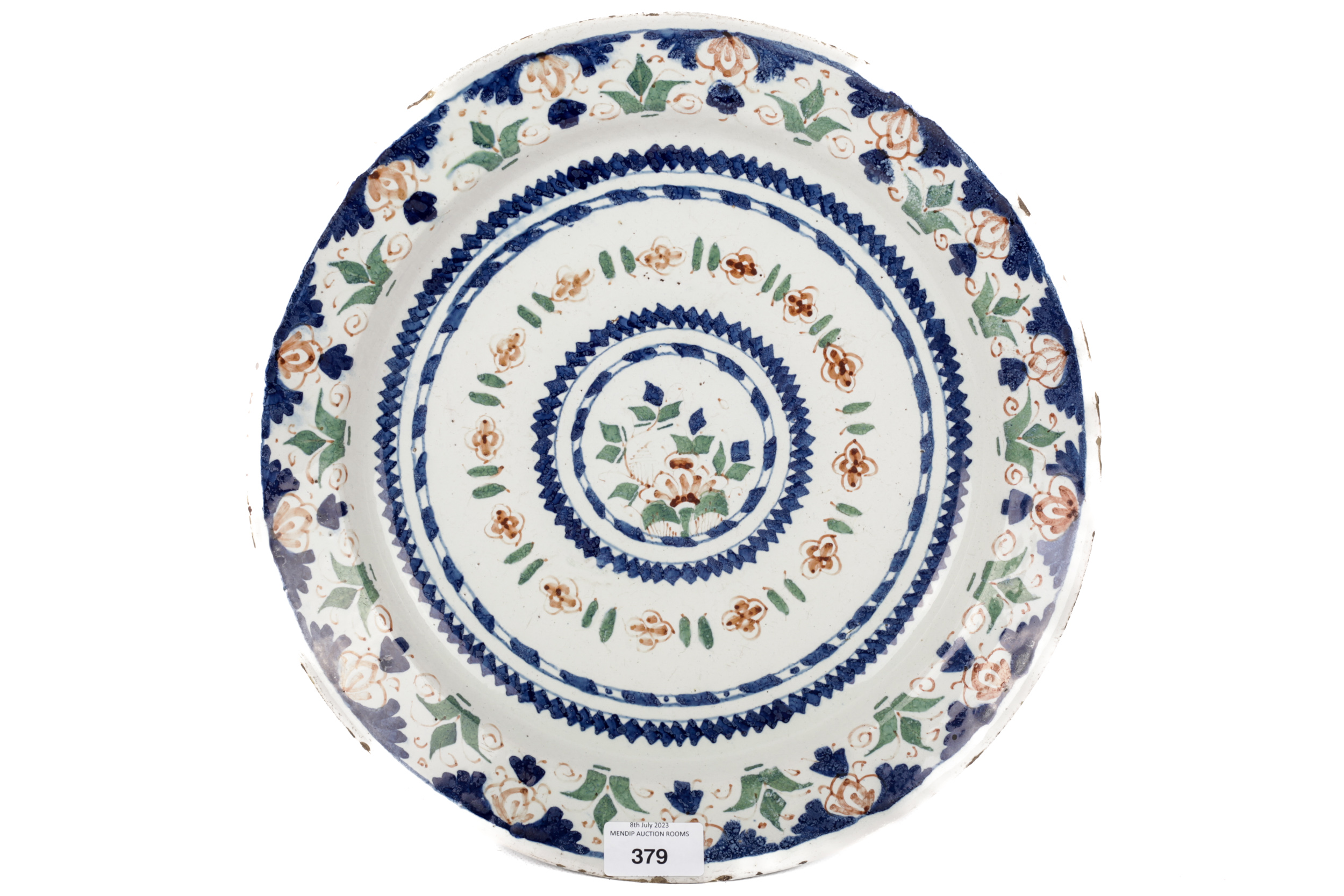 An 18th/19th century Delft footed plate. With polychrome decoration, diameter 32.