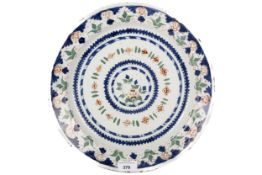 An 18th/19th century Delft footed plate. With polychrome decoration, diameter 32.