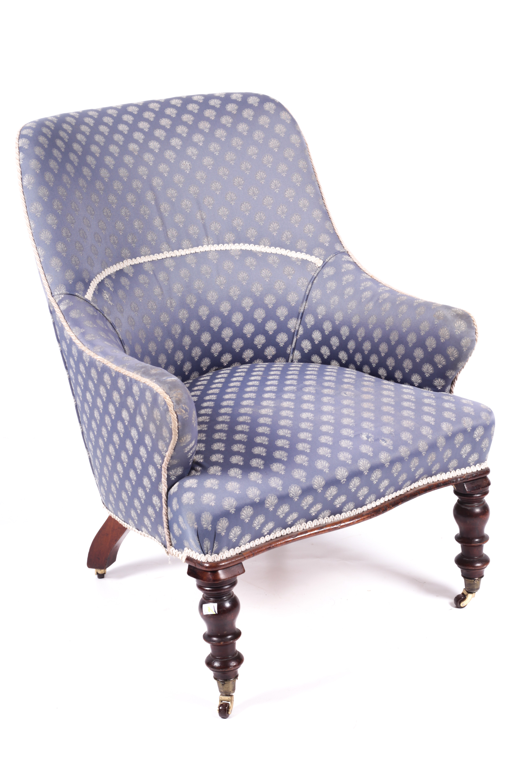 A late Victorian upholstered low armchair.